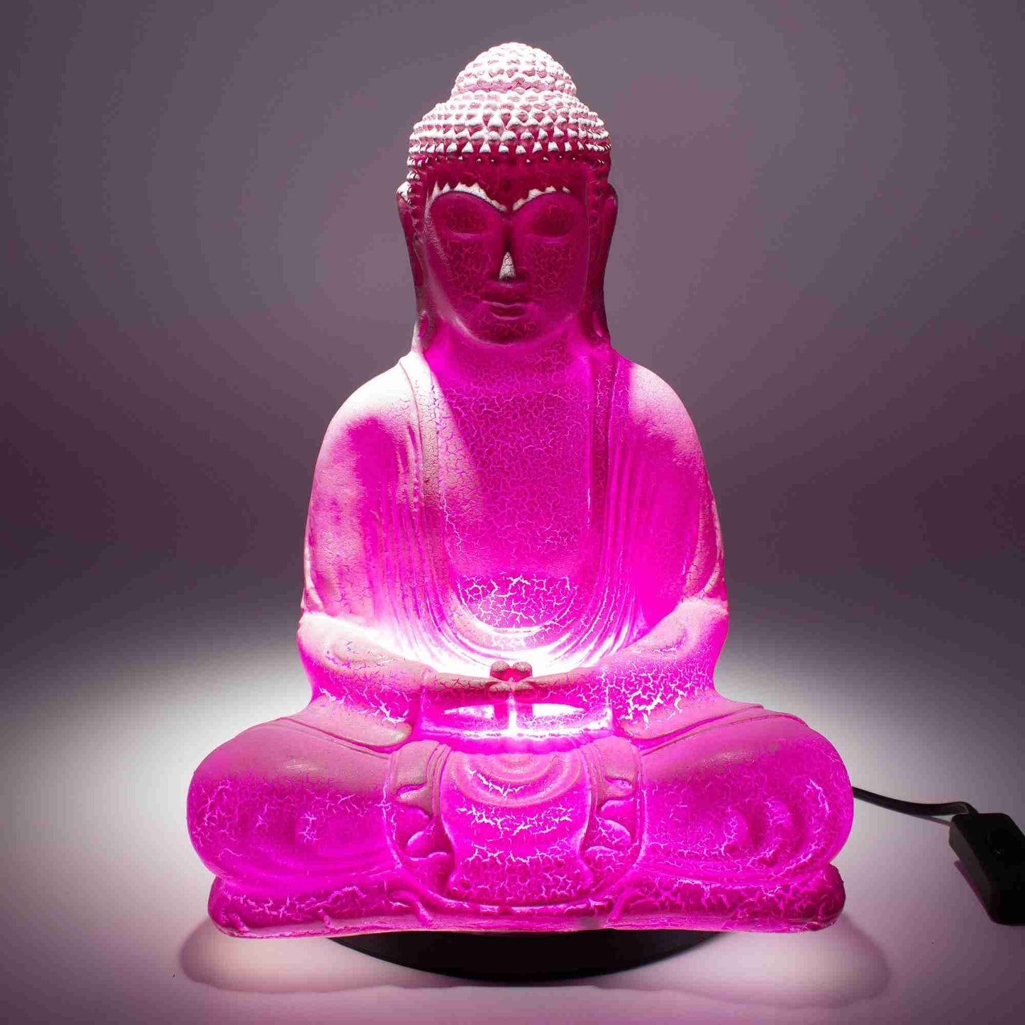 Meditation Buddha Lamp Cherry Crackle with the light on in a dark room.
