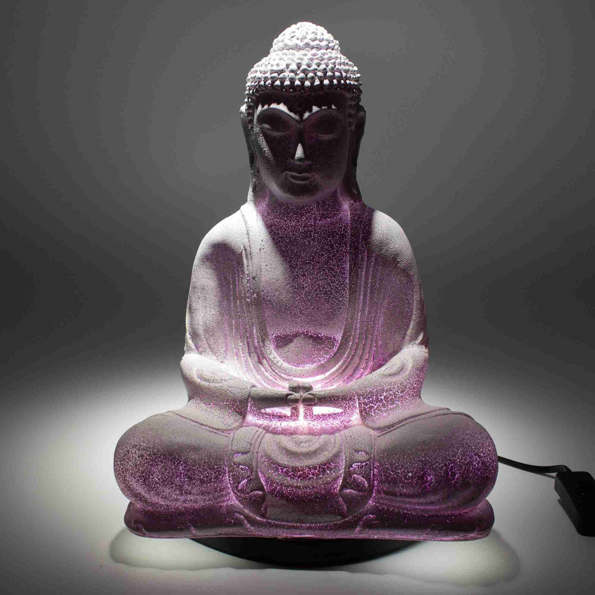 Meditation Buddha Lamp Lavender Crackle with lavender lighting on a grey background.