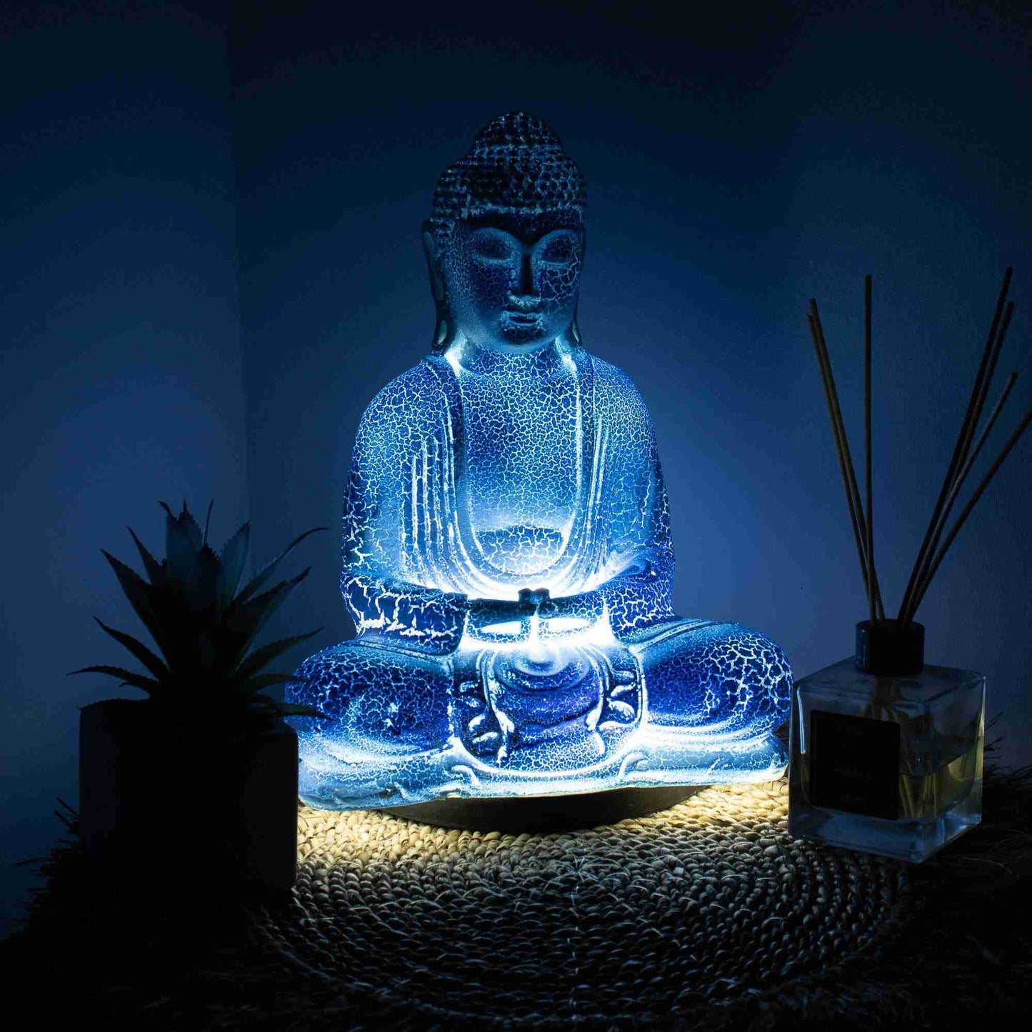 Meditation Buddha Lamp Sky Blue in a dark setting with light turned on