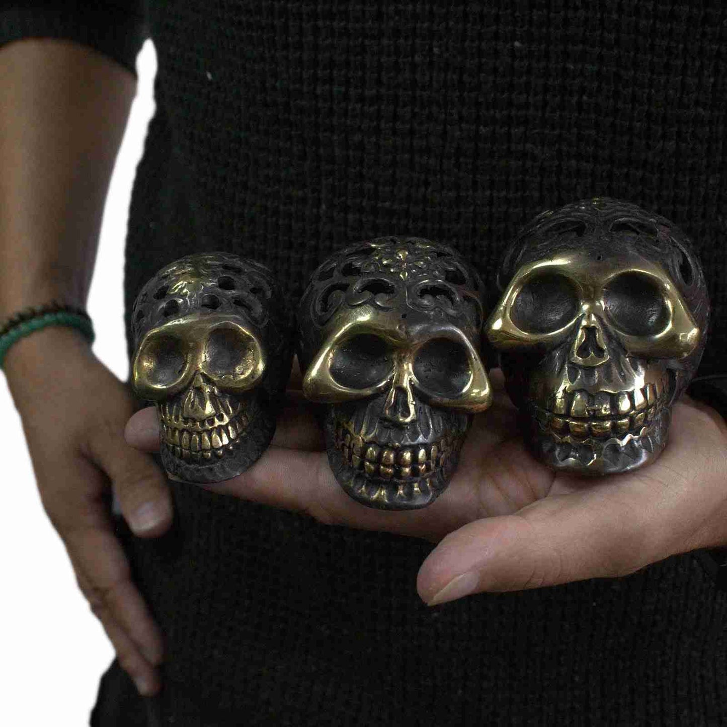 Small Vintage Brass Skull Figurine held in a person's hand.