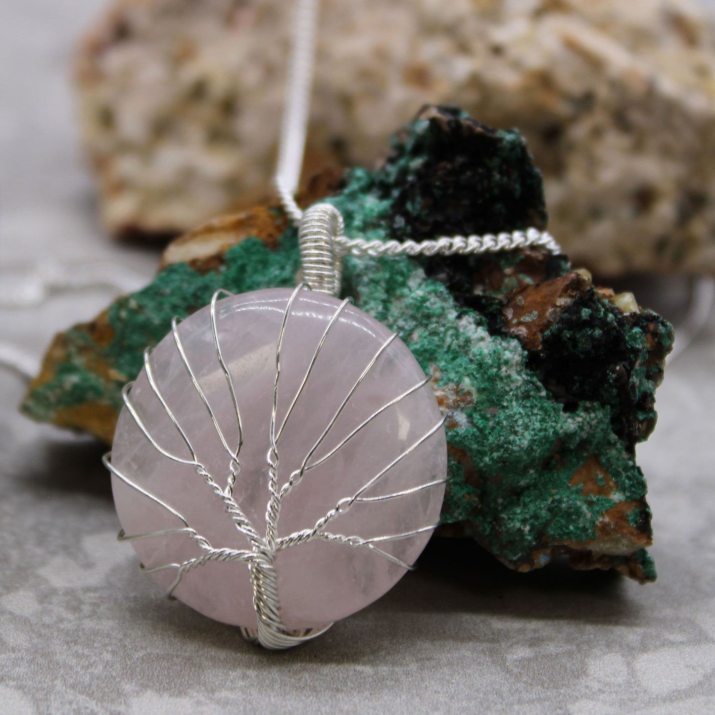 Tree of Life Gemstone Necklace - Rose Quartz on a rock background