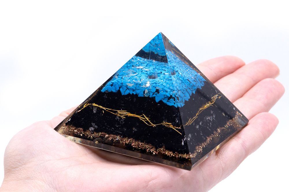 Orgonite Pyramid - Turqoise and Black Tourmaline held in a hand