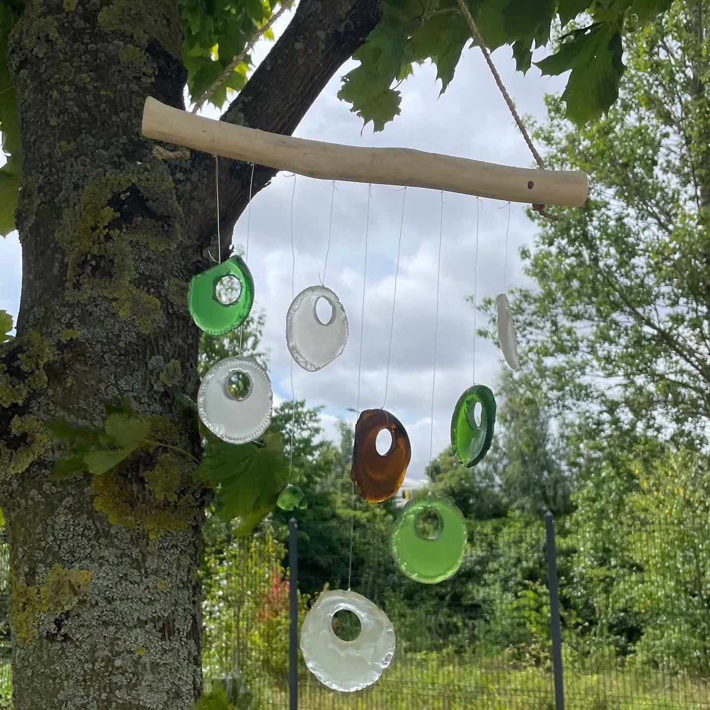 Recycled Bottle Bottoms Glass Wind Chime on a tree branch