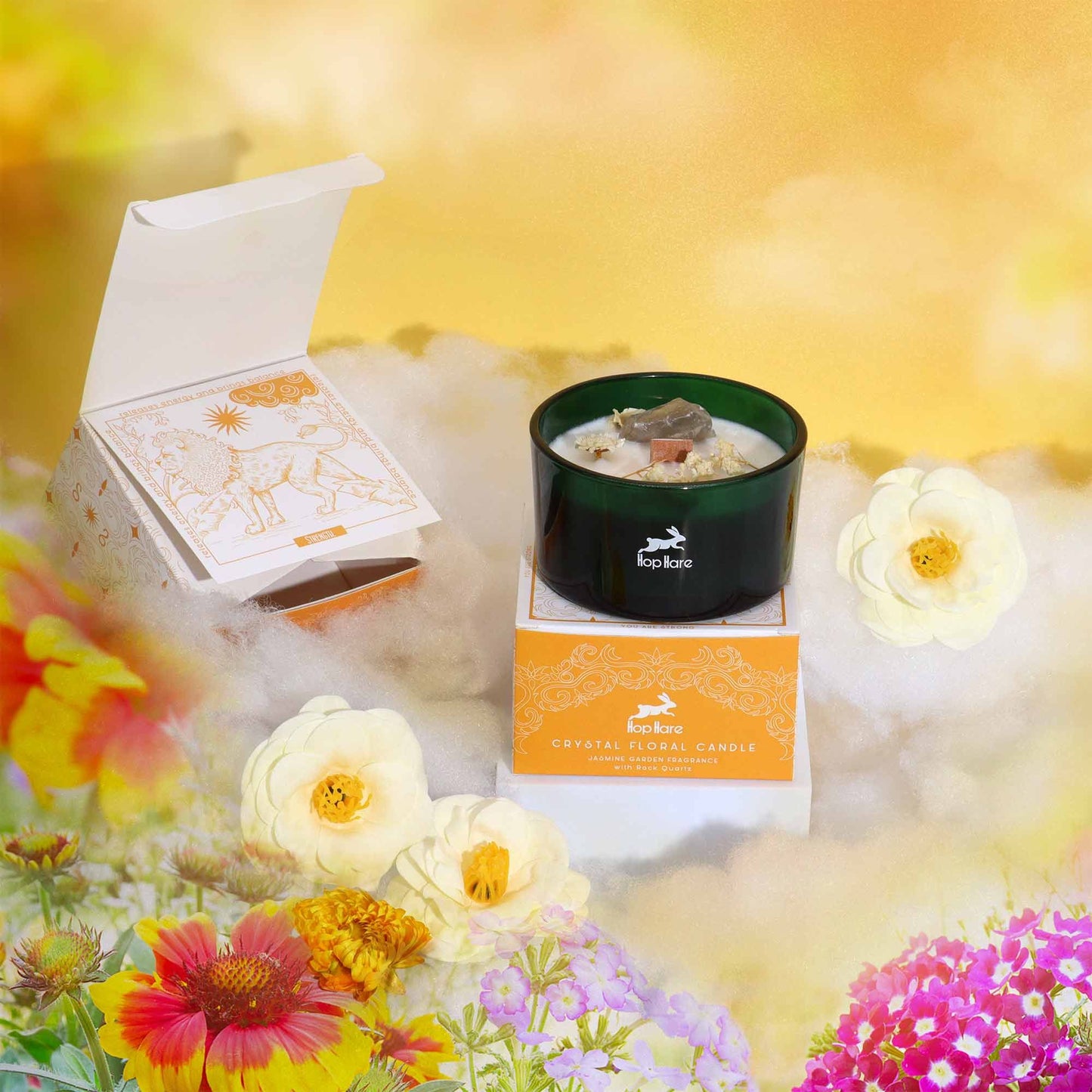 Hop Hare Crystal Magic Flower Candle - The Lion with packaging and flowers on a bright background