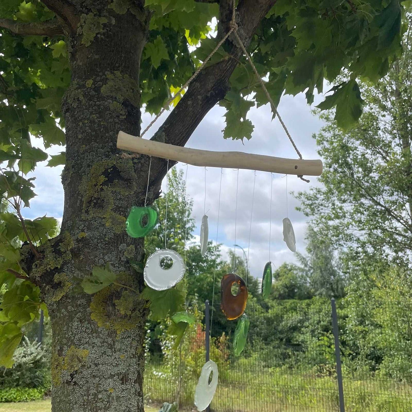 Recycled Bottle Bottoms Glass Wind Chime on a tree branch