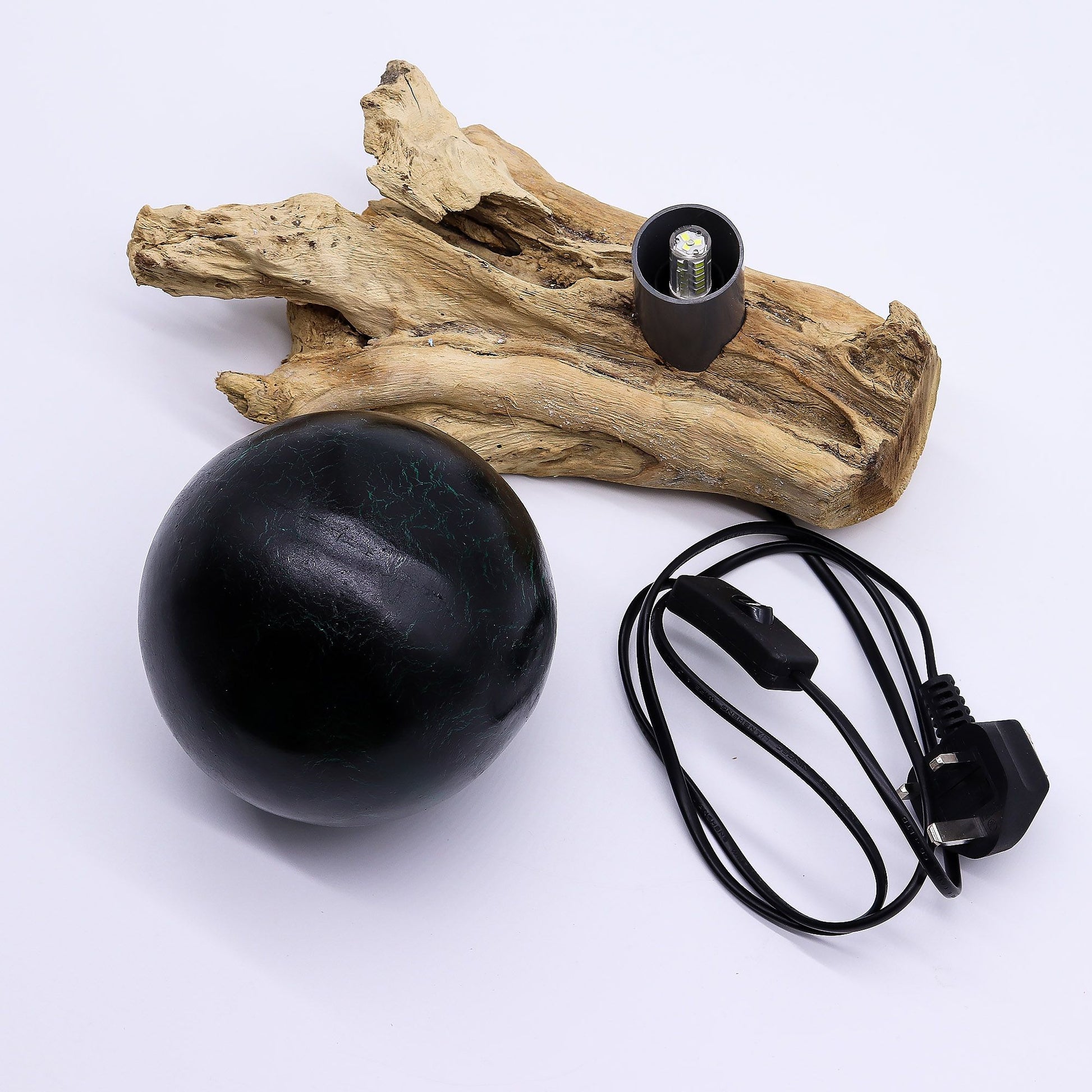 Black spherical object with a cable on a white background