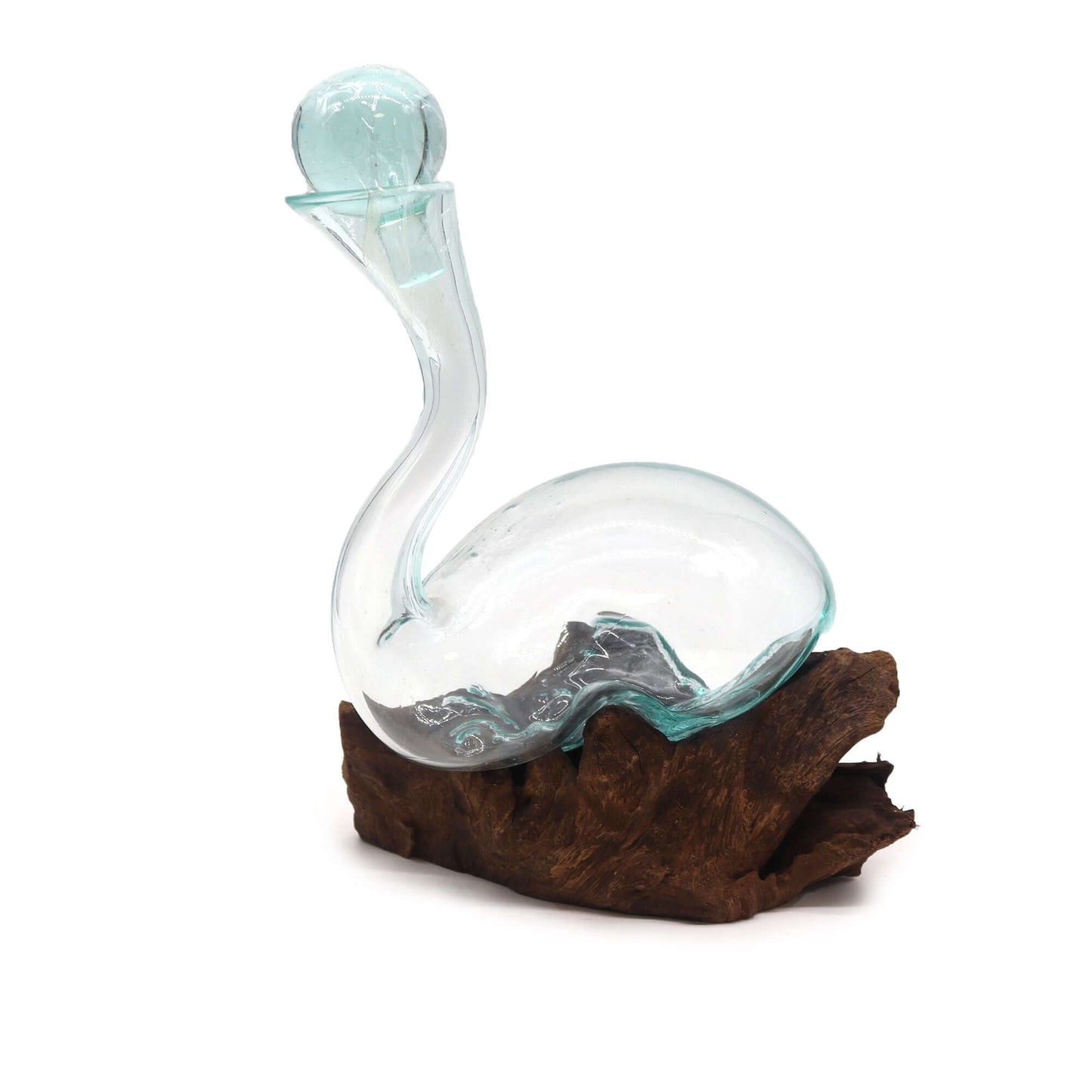 Glass decanter shaped like a swan on a wooden base with a white background