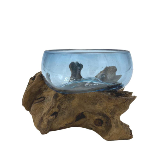Decorative molten glass bowl on a wooden base with a white background