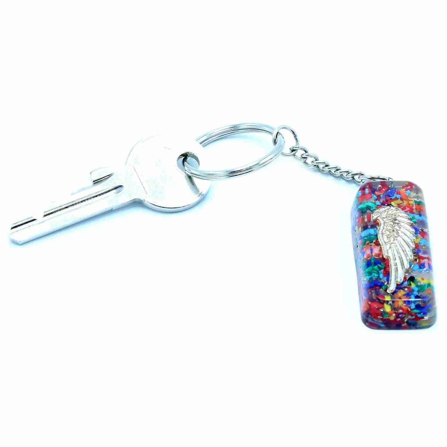 Keychain with a key, multicolored resin piece, and silver angel wing charm on a white background