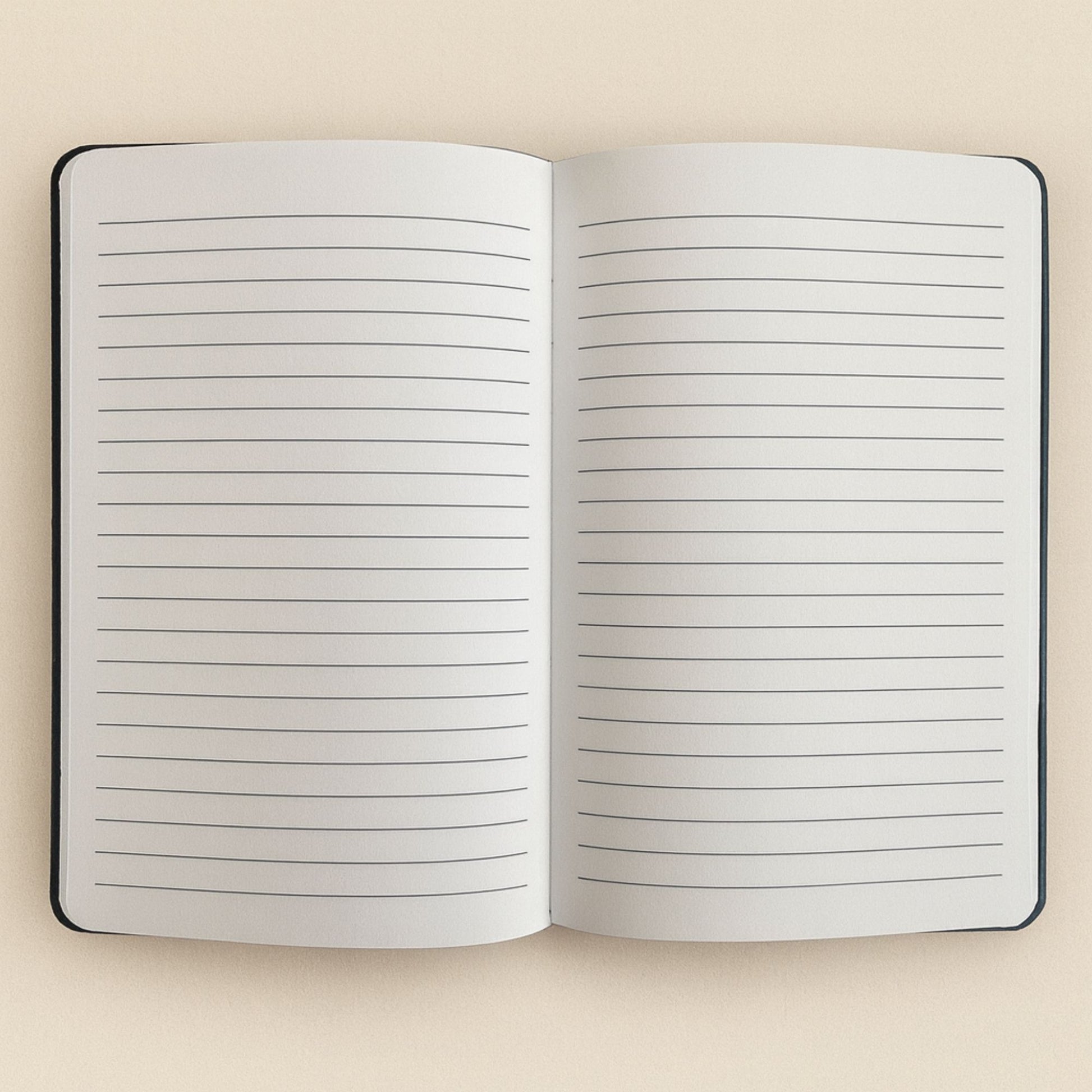 Open notebook with lined pages on a beige background