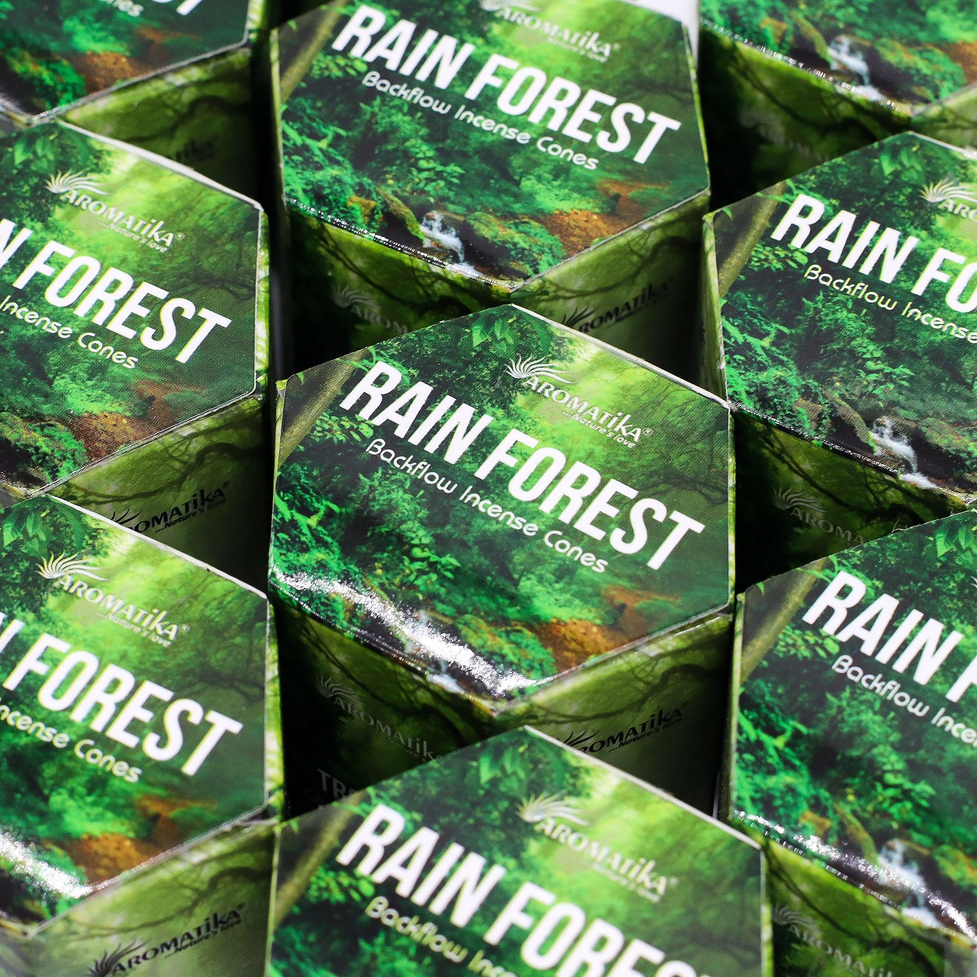 Multiple boxes of Aromatika Rain Forest Backflow Incense Cones stacked together.