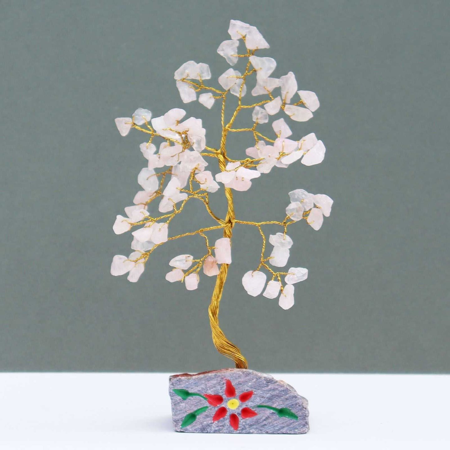 Indian Gemstone Tree - Rose Quartz on Hand-Carved Stone Base (80 Stones) on a grey background