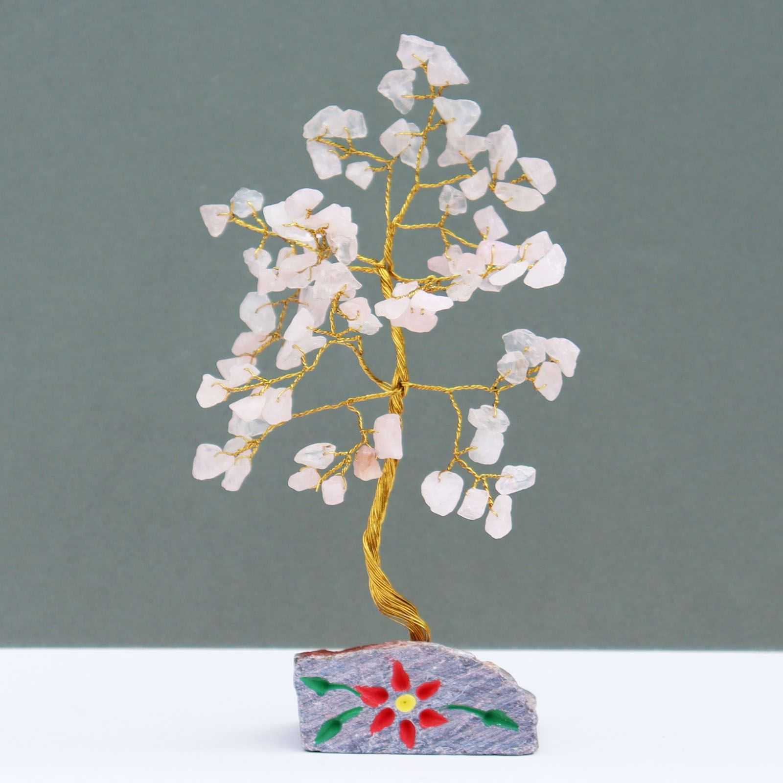 Indian Gemstone Tree - Rose Quartz on Hand-Carved Stone Base (80 Stones) on a grey background