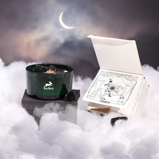 Hop Hare Crystal Magic Flower Candle - The Knight of Swords on a foggy surface with a crescent moon in the background.