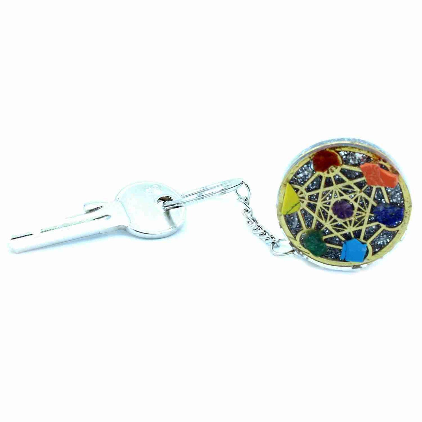 Orgonite Power Keyring - Round Seven Chakra connected to a key on a white background