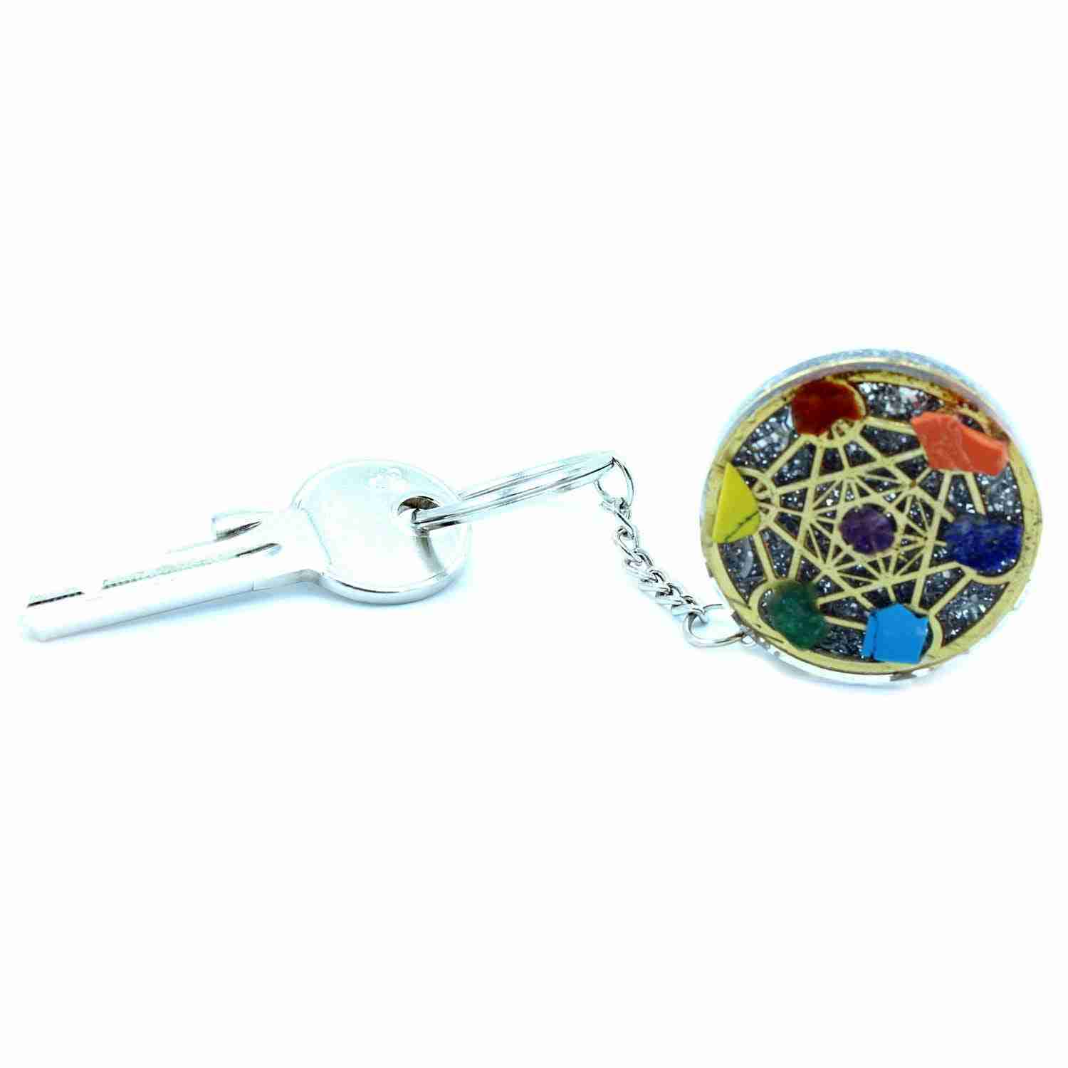 Orgonite Power Keyring - Round Seven Chakra connected to a key on a white background