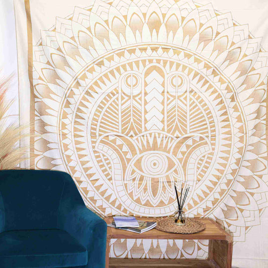 Double Cotton Bedspread + Wall Hanging - Hamsa - White Gold hanging on a wall above a blue chair.