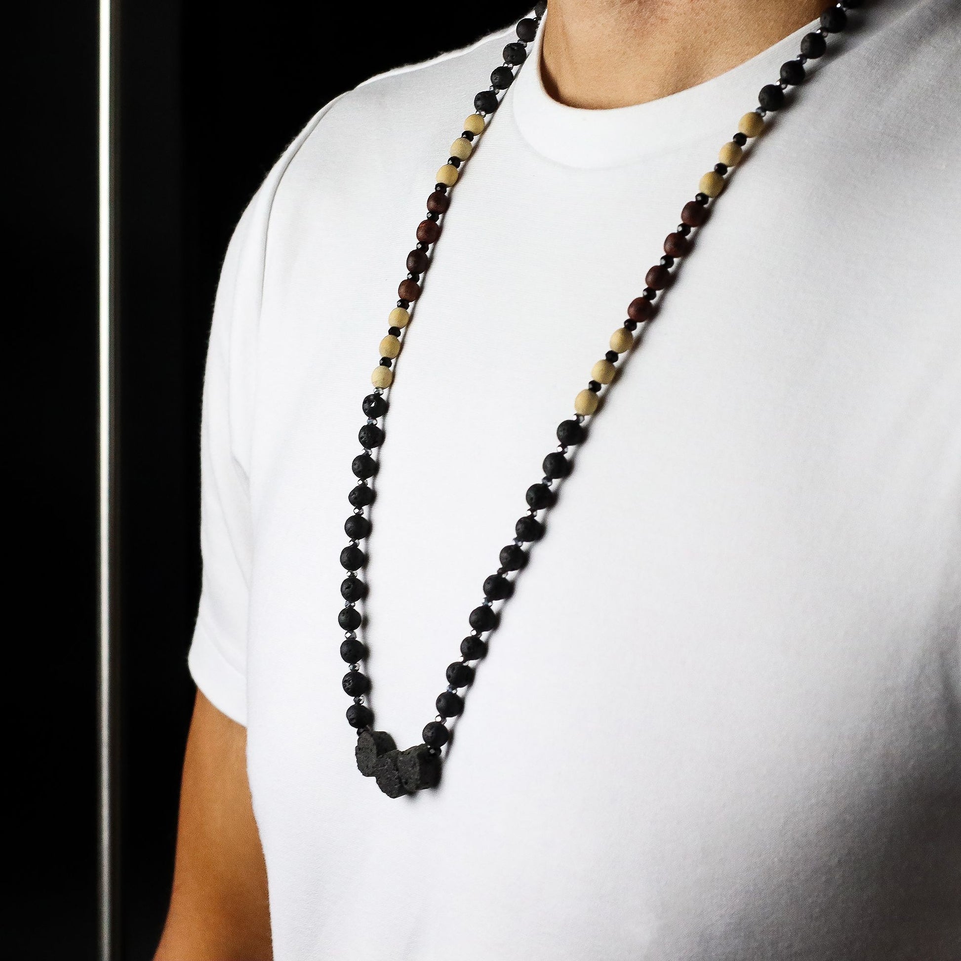 Person wearing an Essence of the Volcano Necklace on a plain background