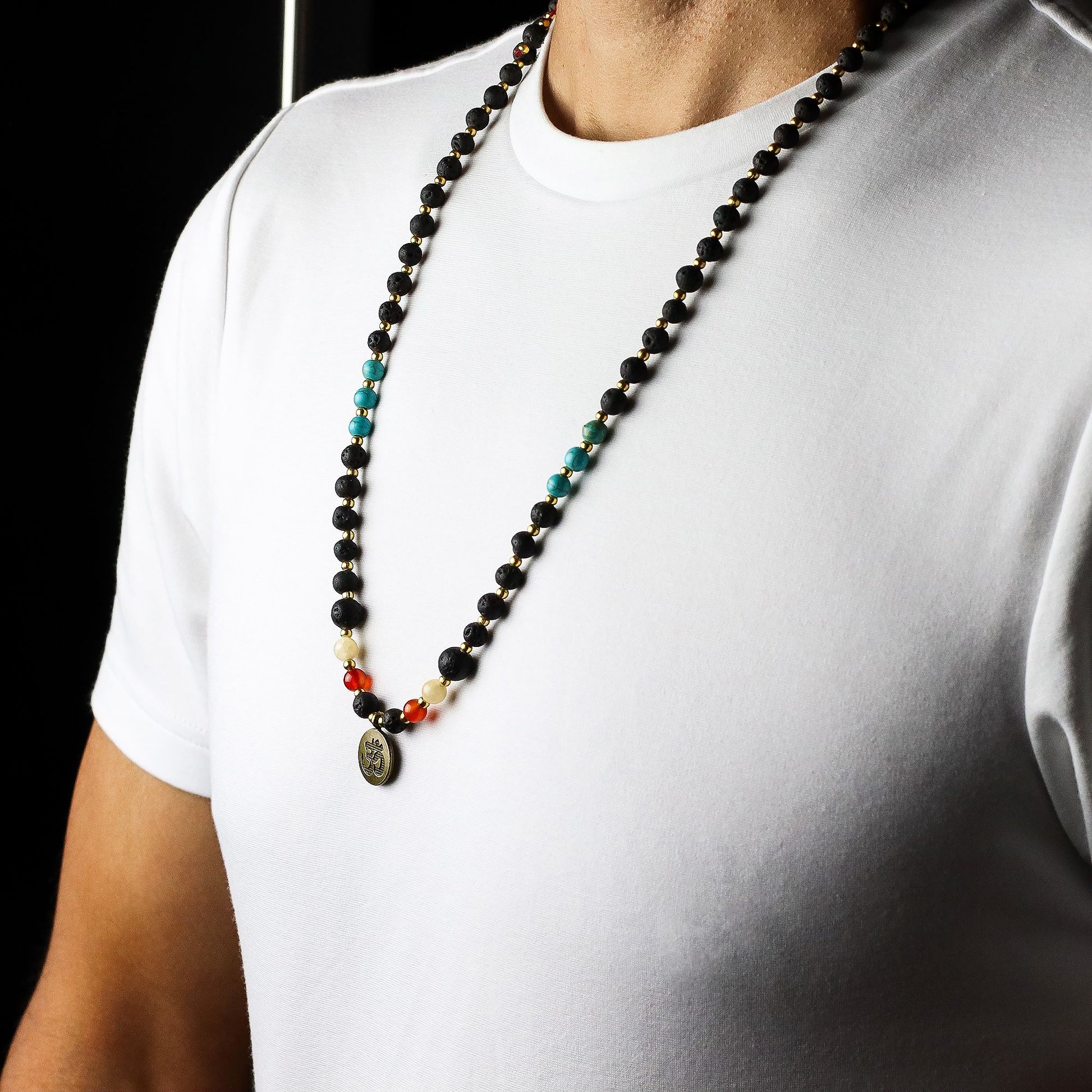 Person wearing an Essence of the Volcano Necklace on a plain white shirt