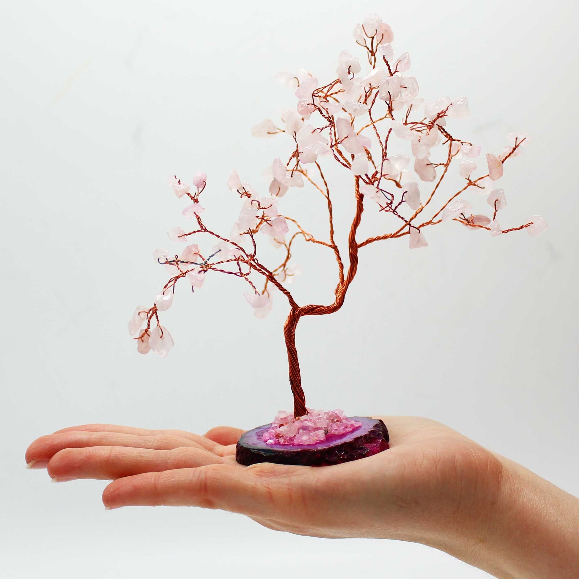 Large Rose Quartz Gemstone Wishing Tree on Pink Agate Base held in a hand