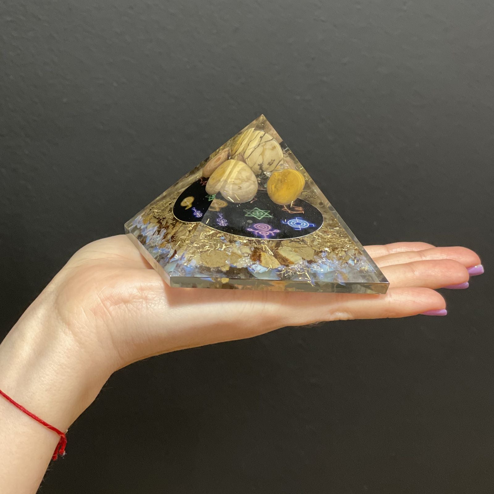 Orgonite Pyramid - Midnight Reiki pleaced on a persons hand