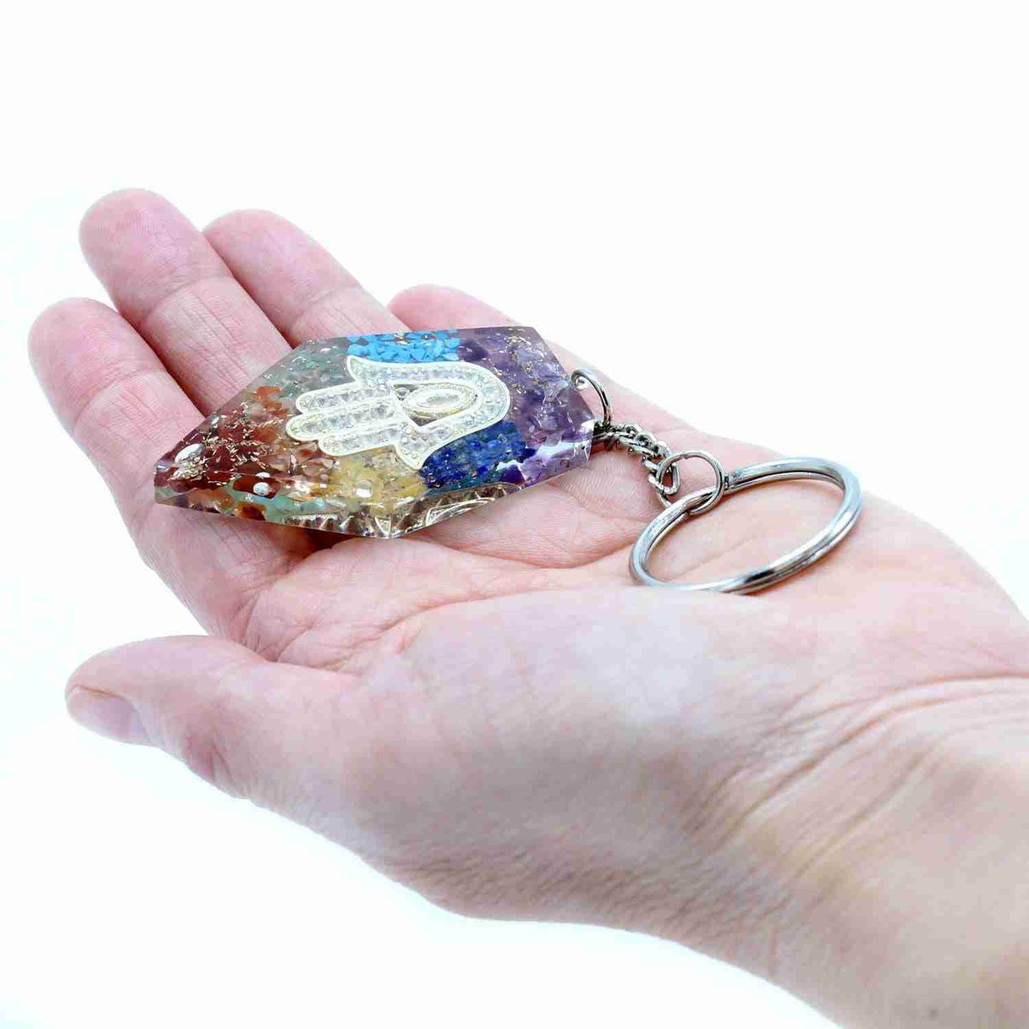 Orgonite Power Keyring - Gemstone Chakra Hamsa held in a hand against a white background