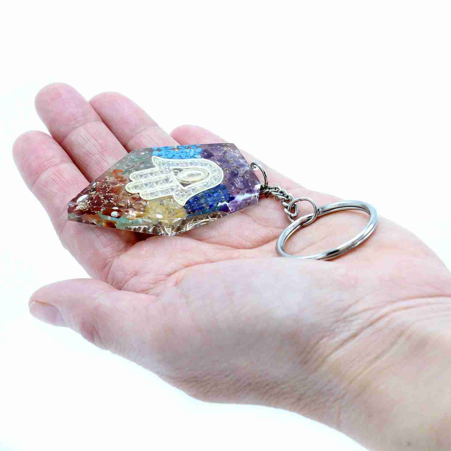 Orgonite Power Keyring - Gemstone Chakra Hamsa held in a hand against a white background