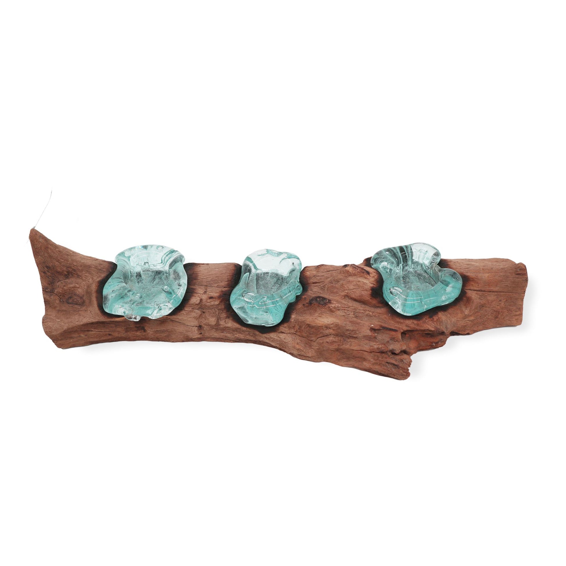 Decorative gift with three turquoise glass pieces on gamal wood against a white background