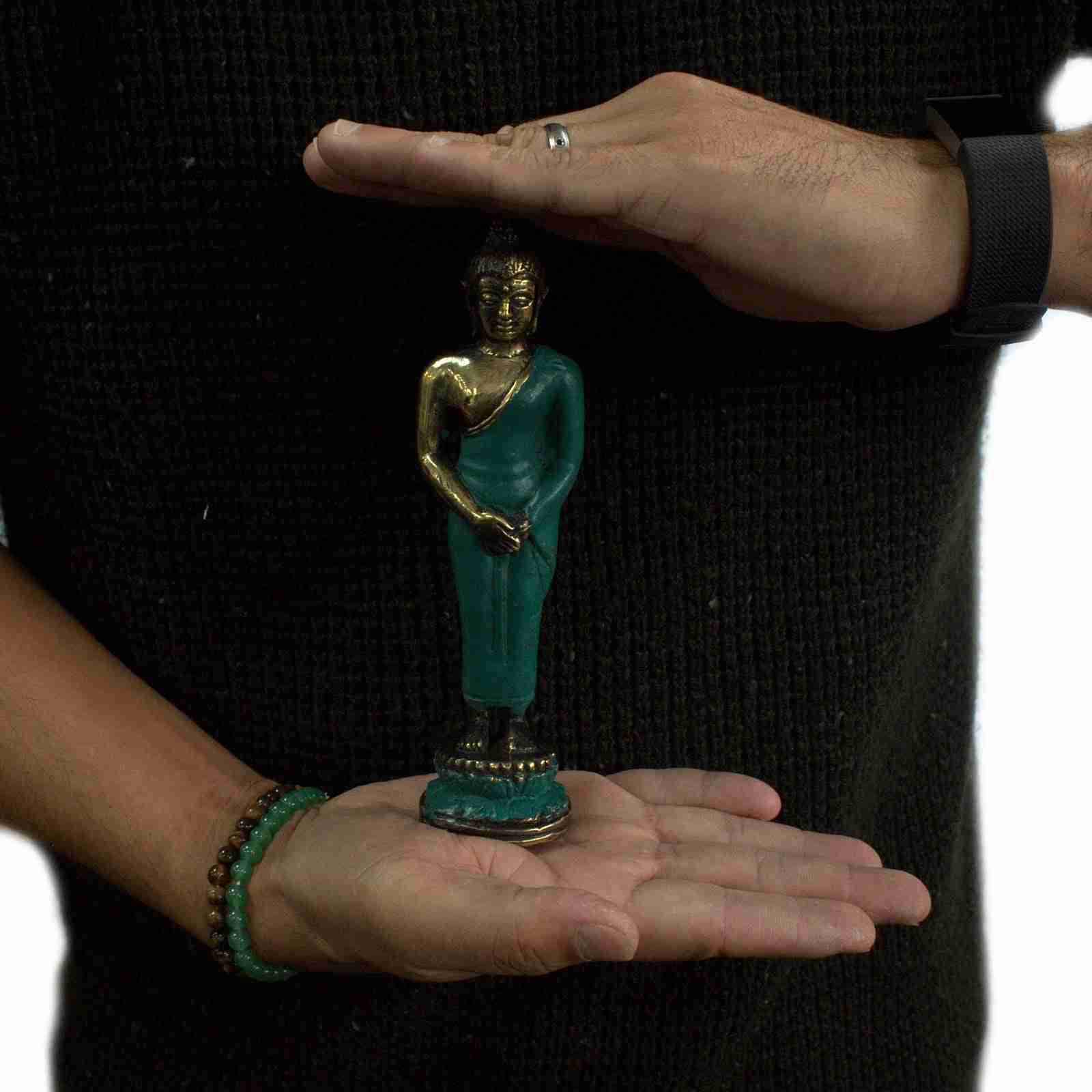 Person holding a Medium Standing Brass Buddha Figurine between their palms