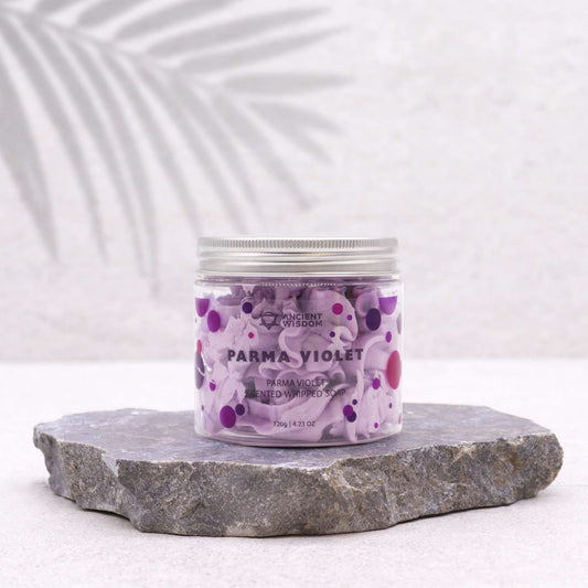 Jar of Parma Violet whipped soap on a stone surface with a white background