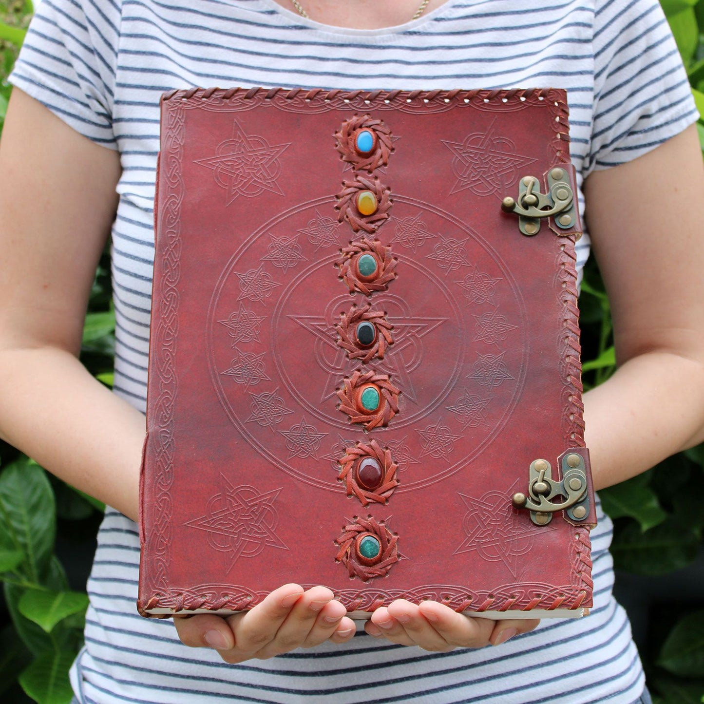 Huge 7 Chakra Leather Book being held by a person to show size