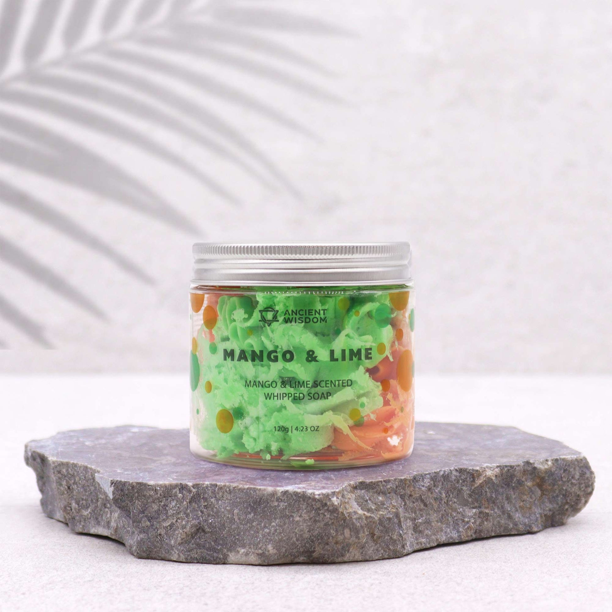Jar of Mango & Lime scented whipped soap on a stone surface with a white background