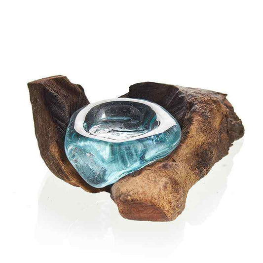 Blue glass candle holder on a wooden branch against a white background