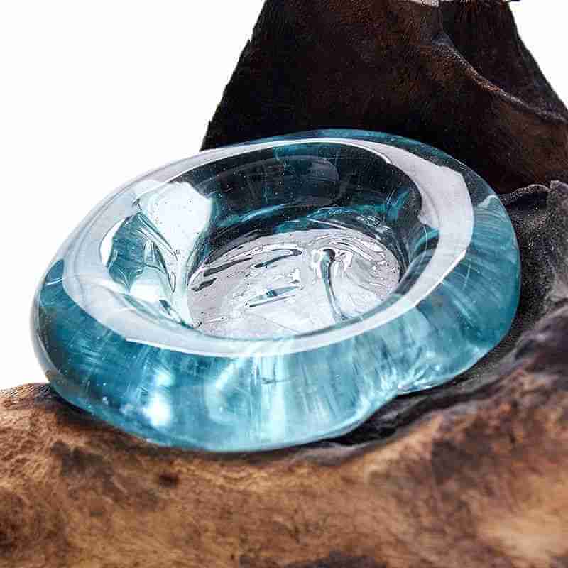 Clear blue glass object on a wooden surface