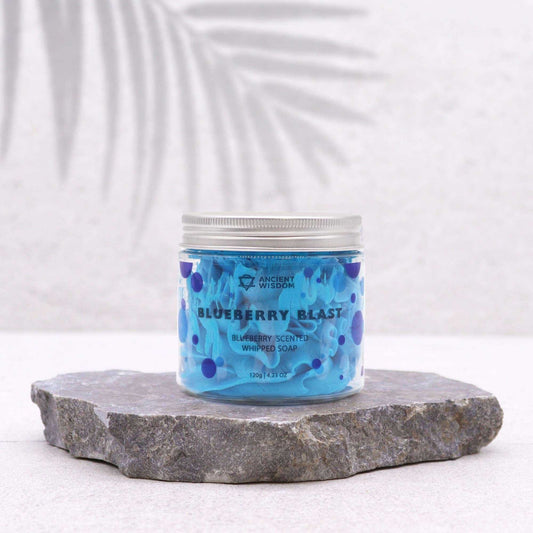 Jar of blueberry blast whipped soap on a stone surface with a white background