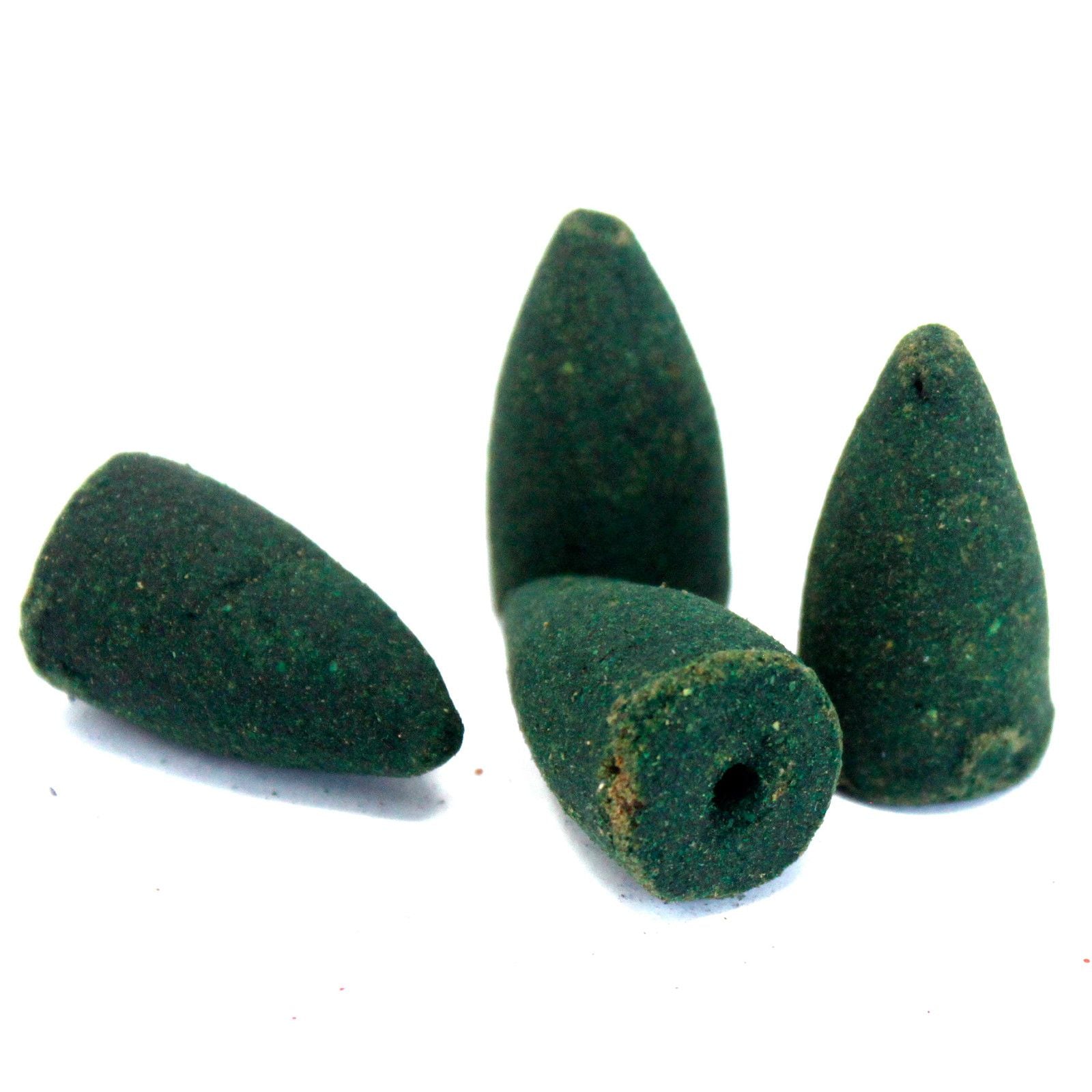 Four green conical incense cones on a white background