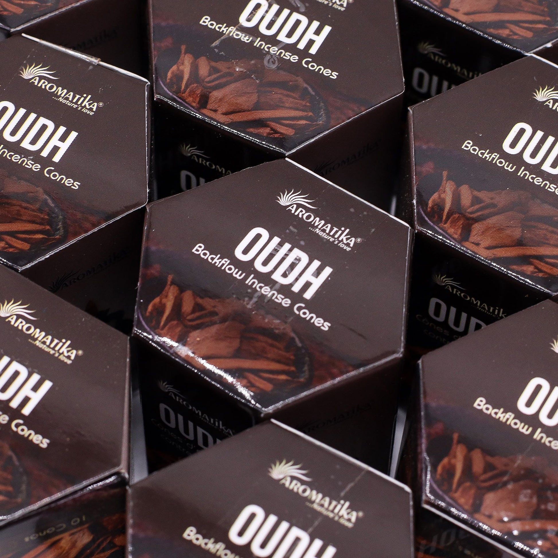 Multiple boxes of Aromatika Oudh Backflow Incense Cones arranged in a pattern.