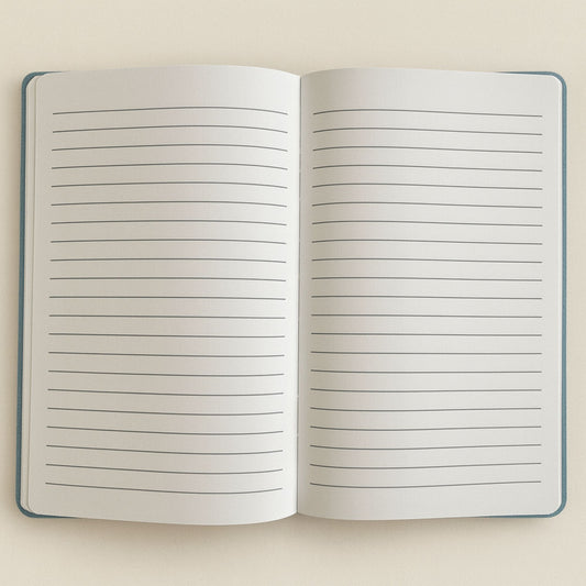 Open notebook with lined pages on a beige background