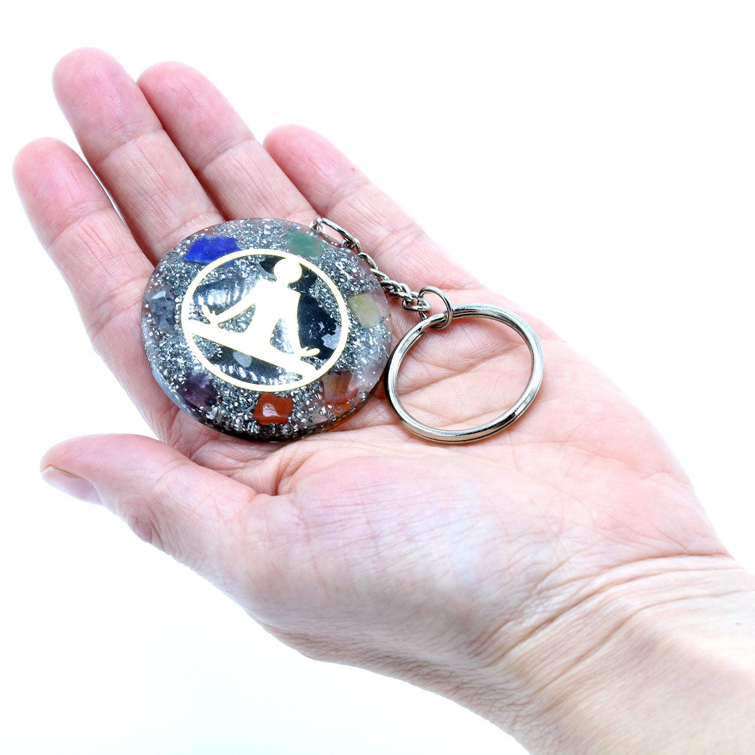 Orgonite Power Keyring - Buddha Seven Chakra held in a hand against a white background