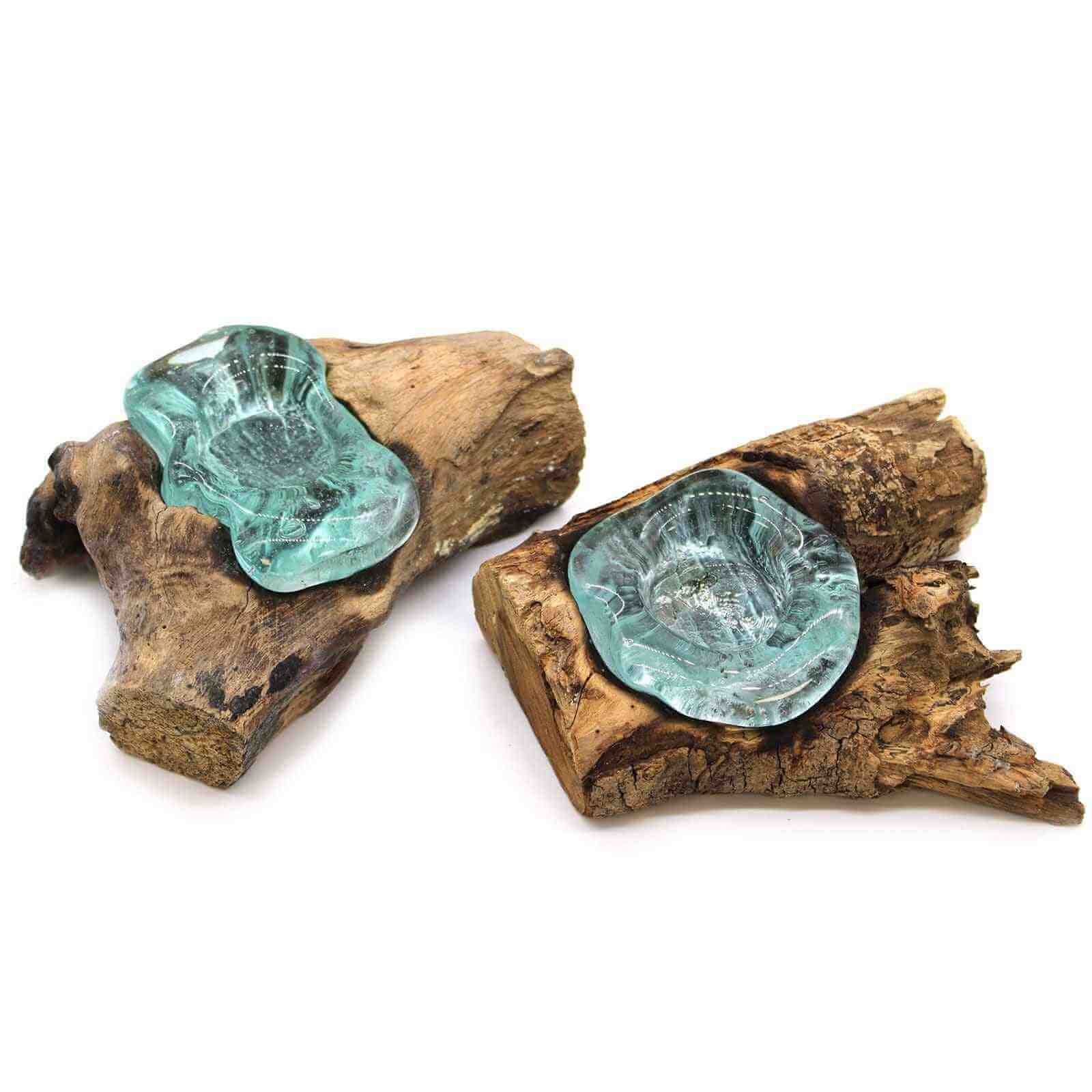 Two pieces of driftwood with green glass inserts on a white background