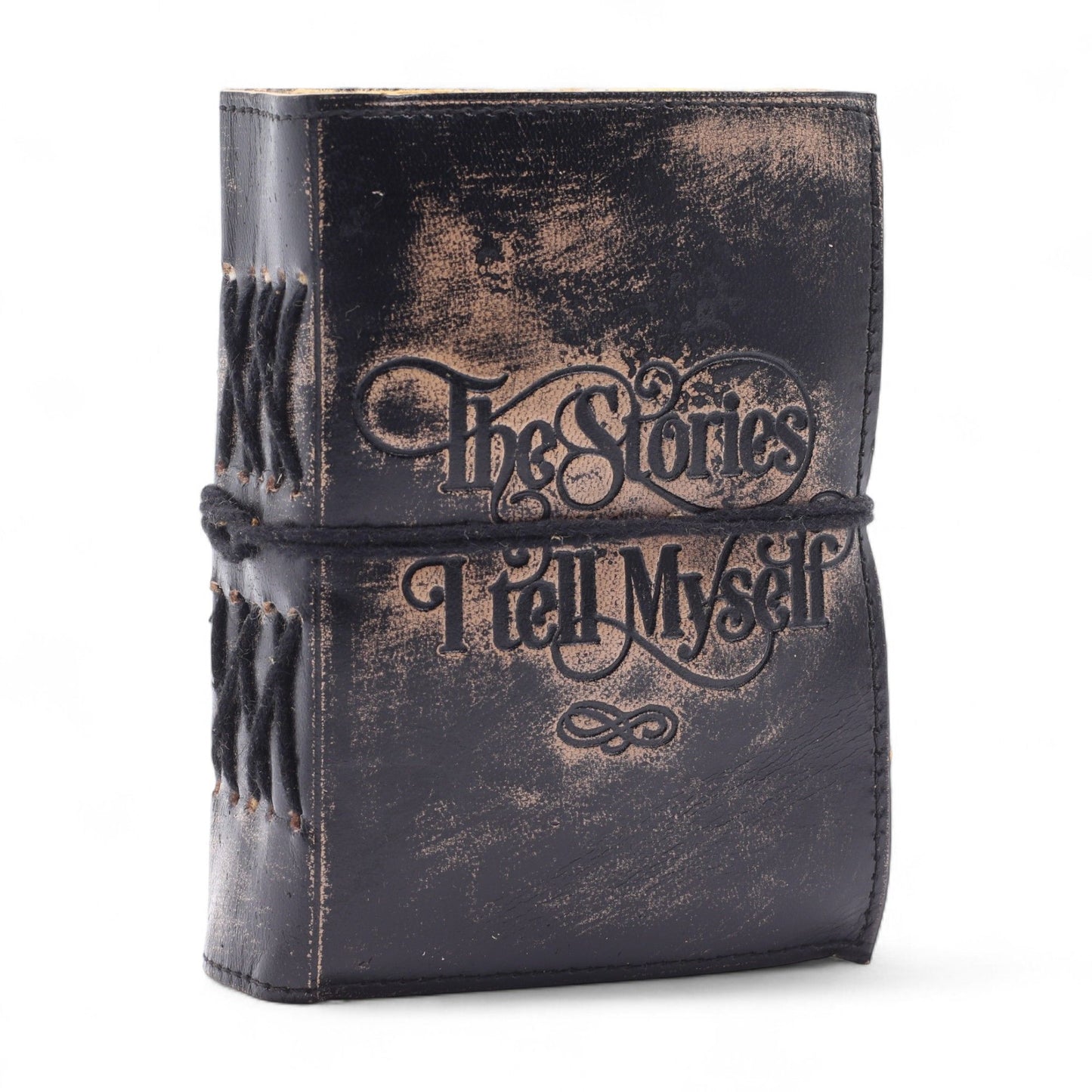 Vintage-style leather-bound book with 'The Stories I Tell Myself' text on a white background