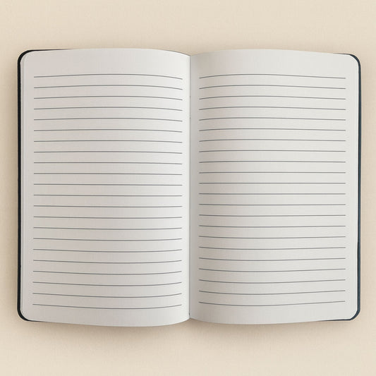 Open notebook with lined pages on a beige background