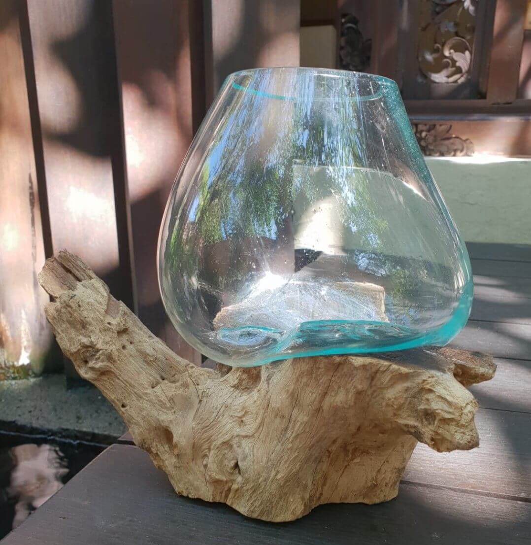Molten glass bowl on a wooden base outdoors