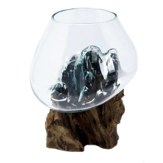 Molten Glass bowl with a rock formation on a wooden base against a white background