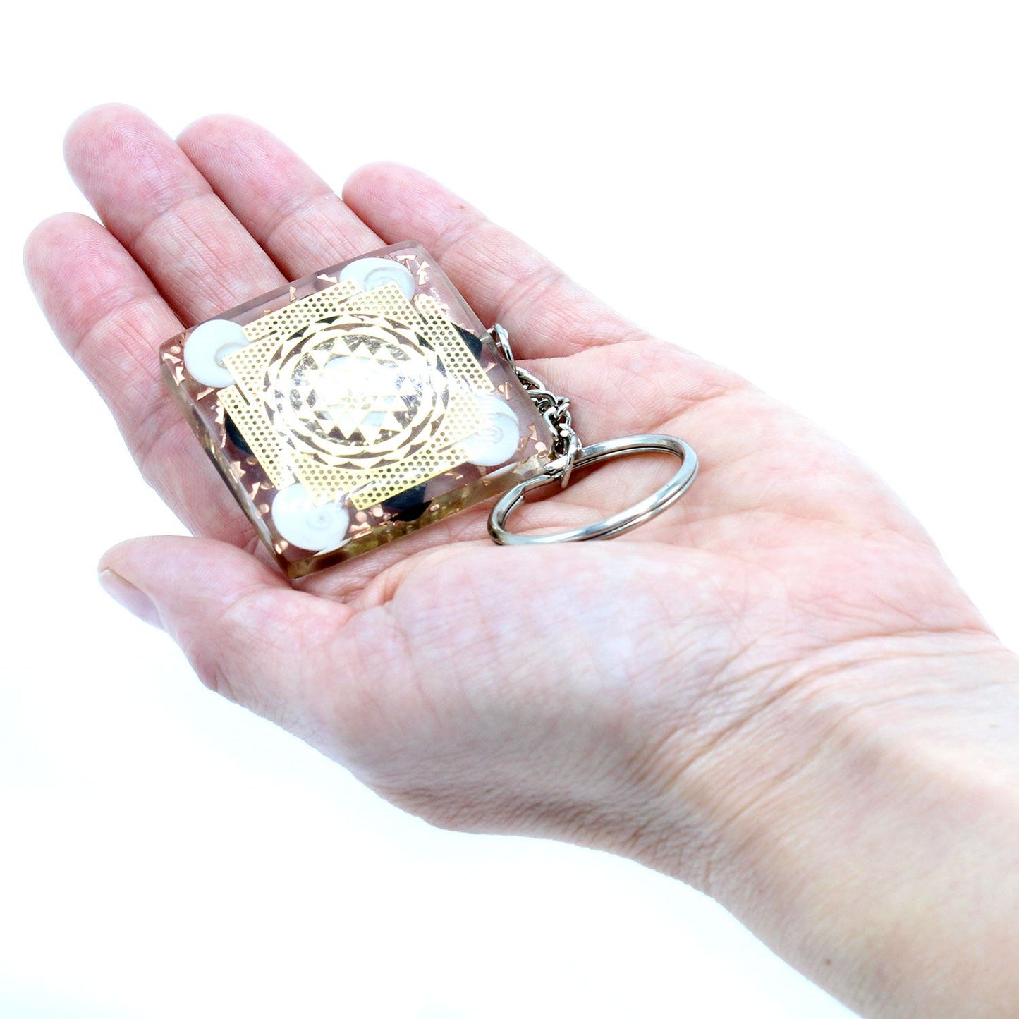 Orgonite Power Keyring - Home Protect Tourmaline held in a hand against a white background