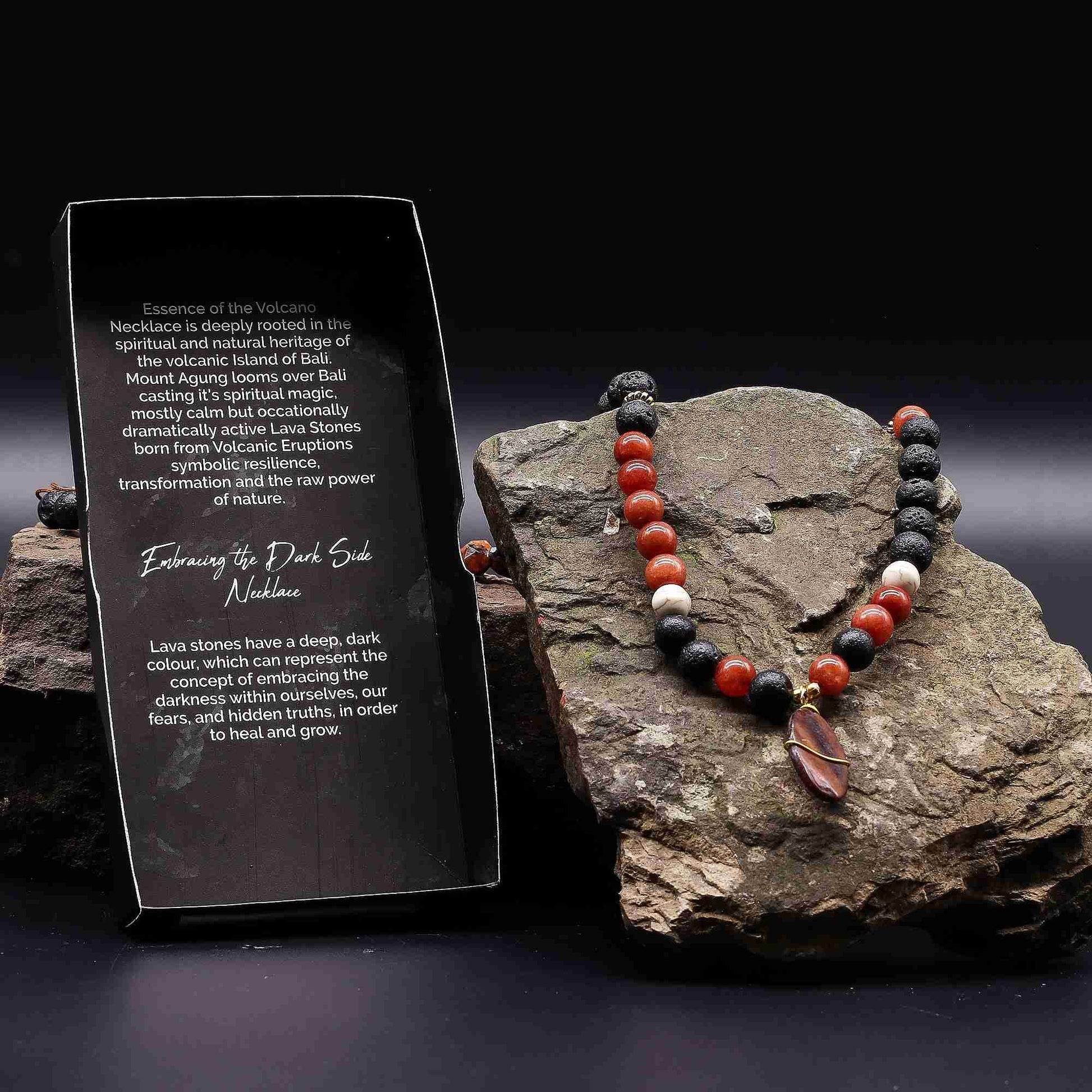 Essence of the Volcano Necklace - Protection displayed on a rock