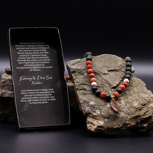 Essence of the Volcano Necklace - Protection displayed on a rock