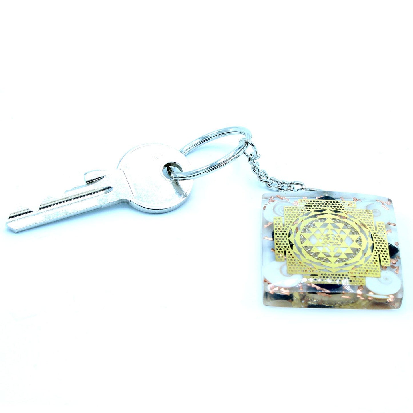 Orgonite Power Keyring - Home Protect Tourmaline connected to key on a white background