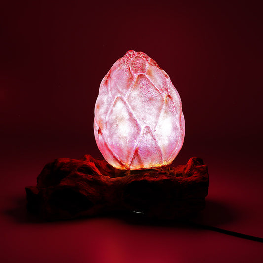 Pink crystal egg-shaped lamp on a dark red background