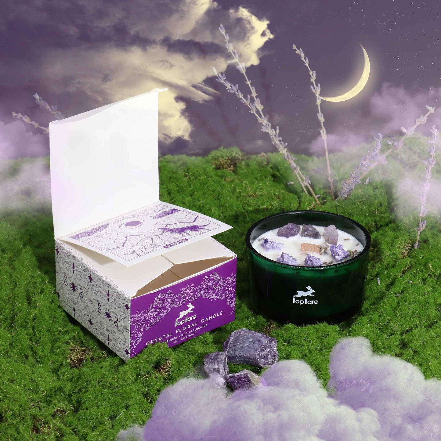 Hop Hare Crystal Magic Flower Candle - The Moon with packaging on a grassy field under a moonlit sky